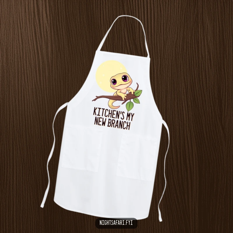 Funny apron showing a cute gecko with big eyes clinging to a branch under the moon, adding kitchen flair.