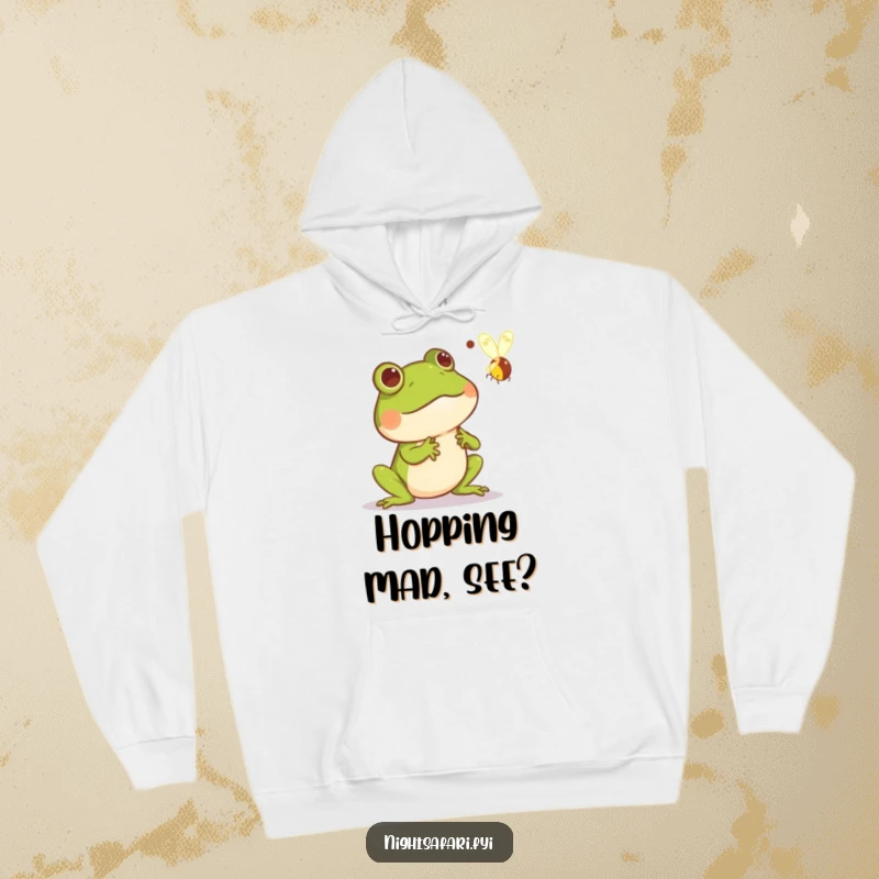 Funny hoodie with a comically startled frog caught in mid-air reacting to a bright, zipping firefly, ideal for fans of humorous wildlife art.