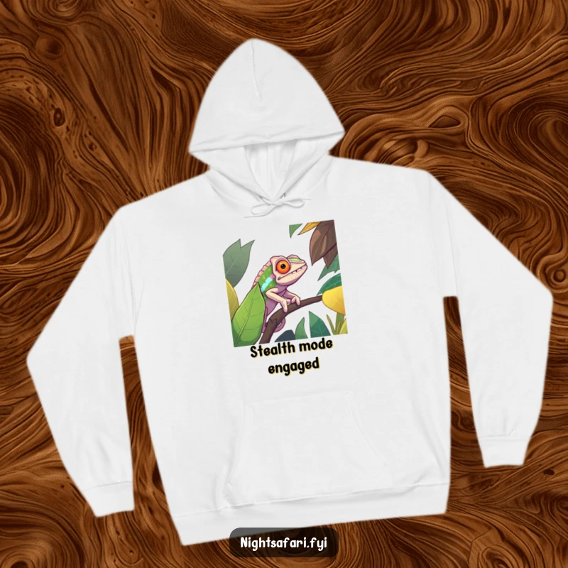 Funny hoodie displaying a determined chameleon flawlessly camouflaged against a lush, vibrant jungle leaf, perfect for fans of witty apparel.
